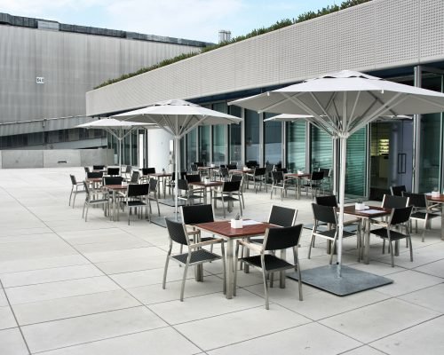 Modern architecture - fashionable outdoor cafe or restaurant tables in Munich, Germany